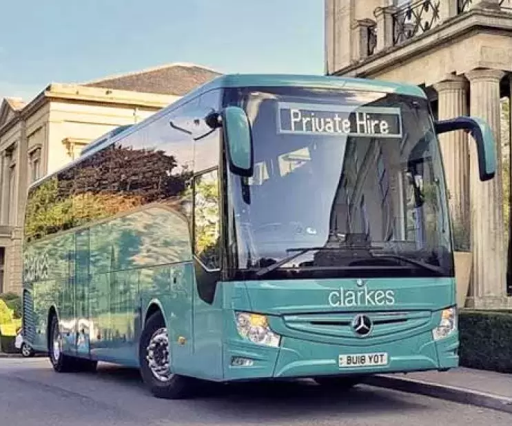 Clarkes of London Coach parked outside building