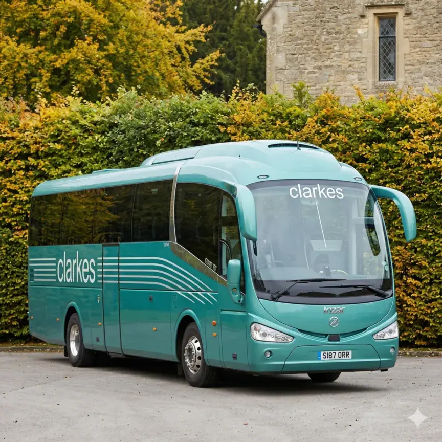Executive green coach parked outside a building with modern design and tinted windows